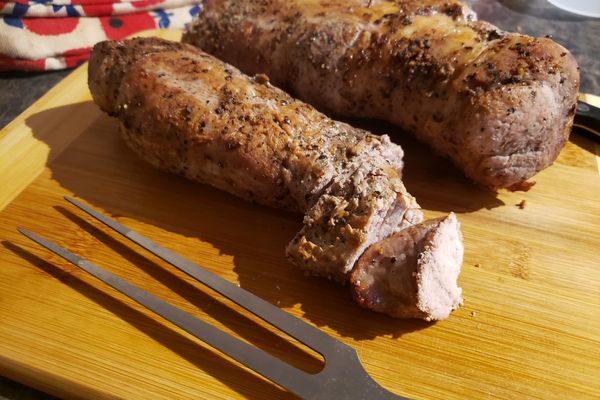Roasted pork tenderloin on a wooden cutting board